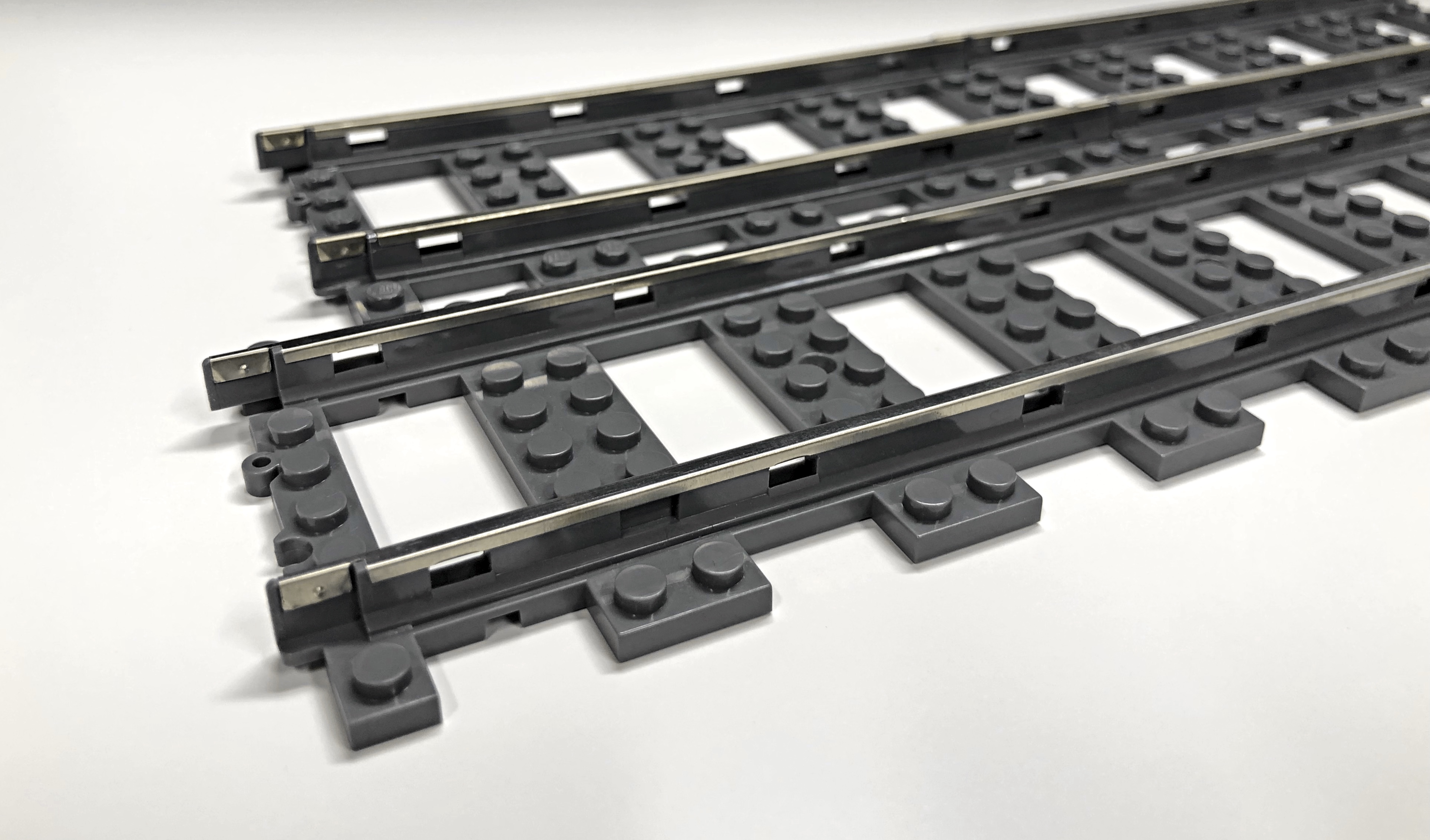 Pre-product S32 straight track (front), LEGO® 9V straight tracks (back)